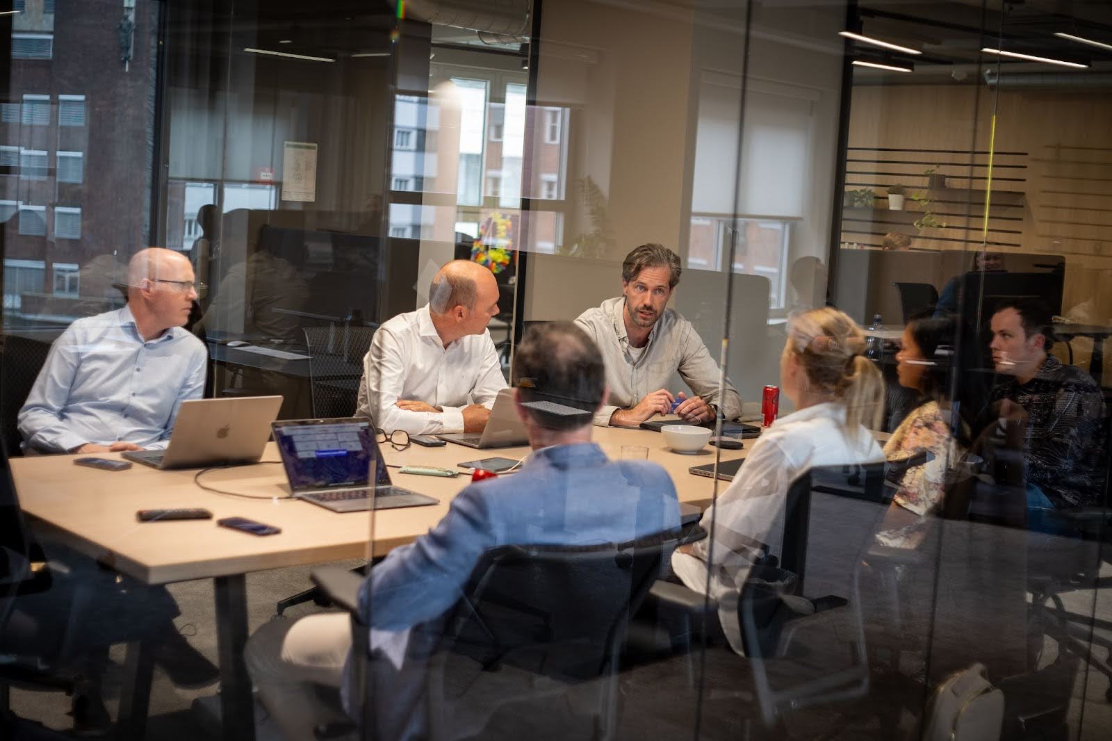 Employees sitting at a conference table in a meeting